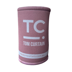 Pink stubby holder in blue with the Tom Curtain logo on it (TC with a line and dot)