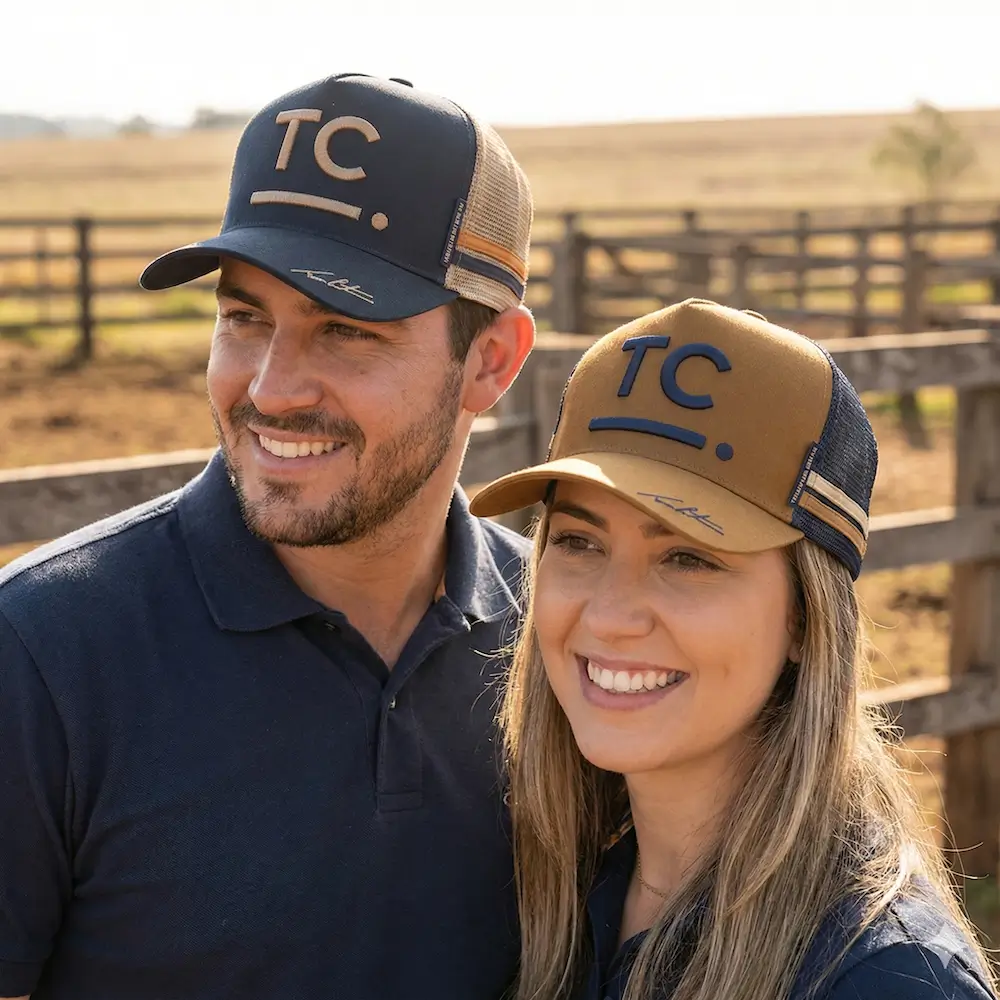 A man and a woman wearing 2026 edition Tom Curtain Trucker Caps