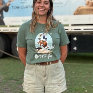 Tom Curtain crew member Hannah showcasing the front of the Here's To You Anniversary T-shirt