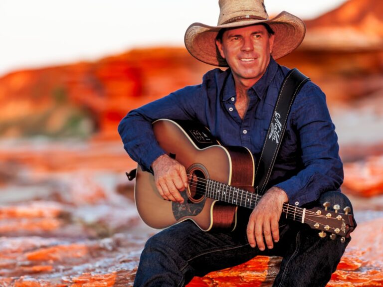 Tom Curtain amongst the red outback landscape.